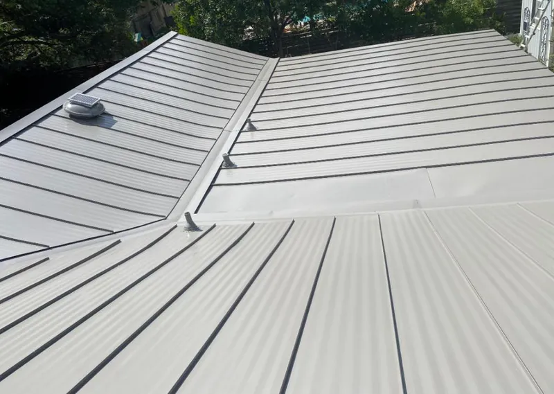 Solar attic fan installed on a metal roof for Roof Ventilation in Kochville